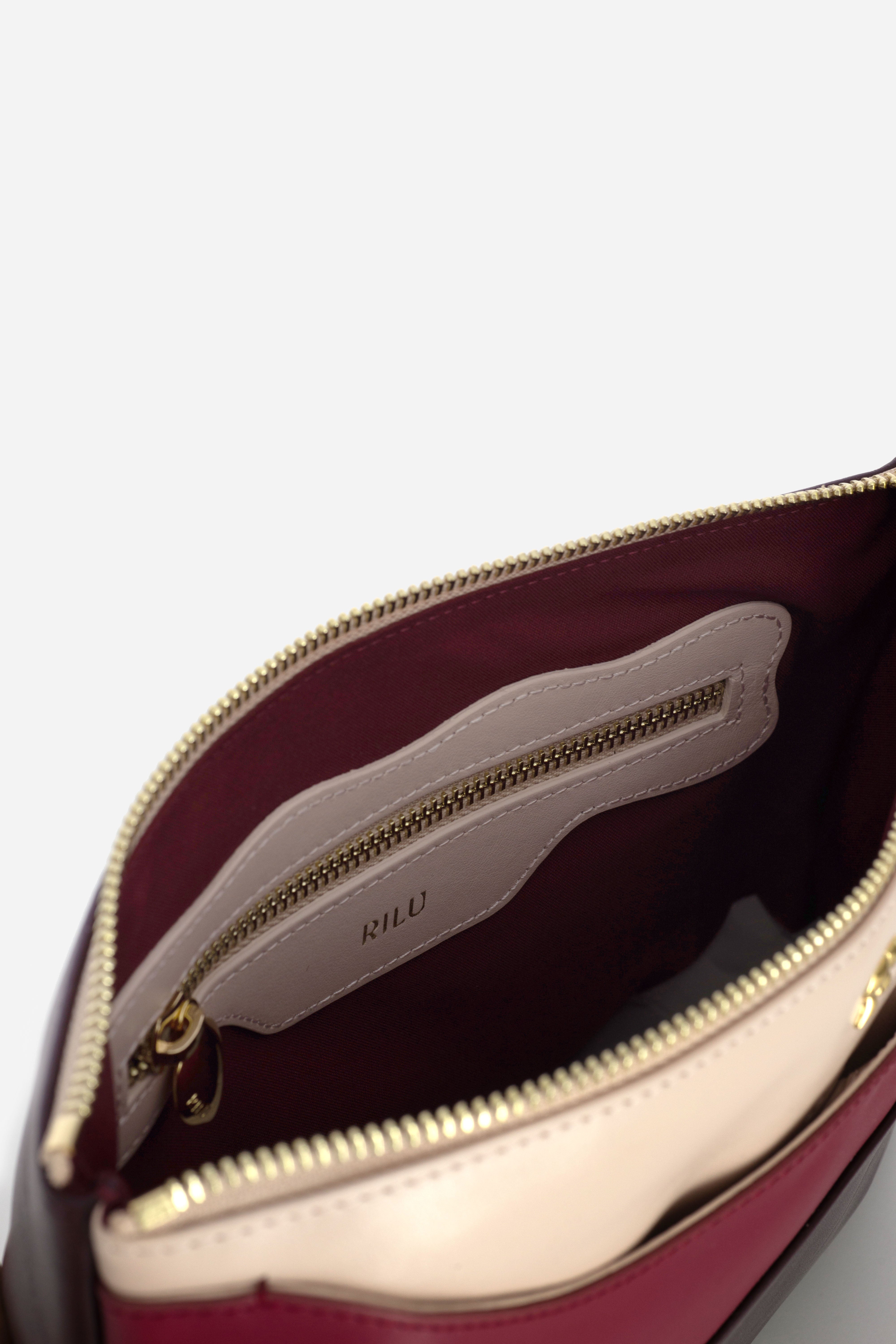Rilu Ivy leather clutch close-up of the powder, cherry, and burgundy leather fusion