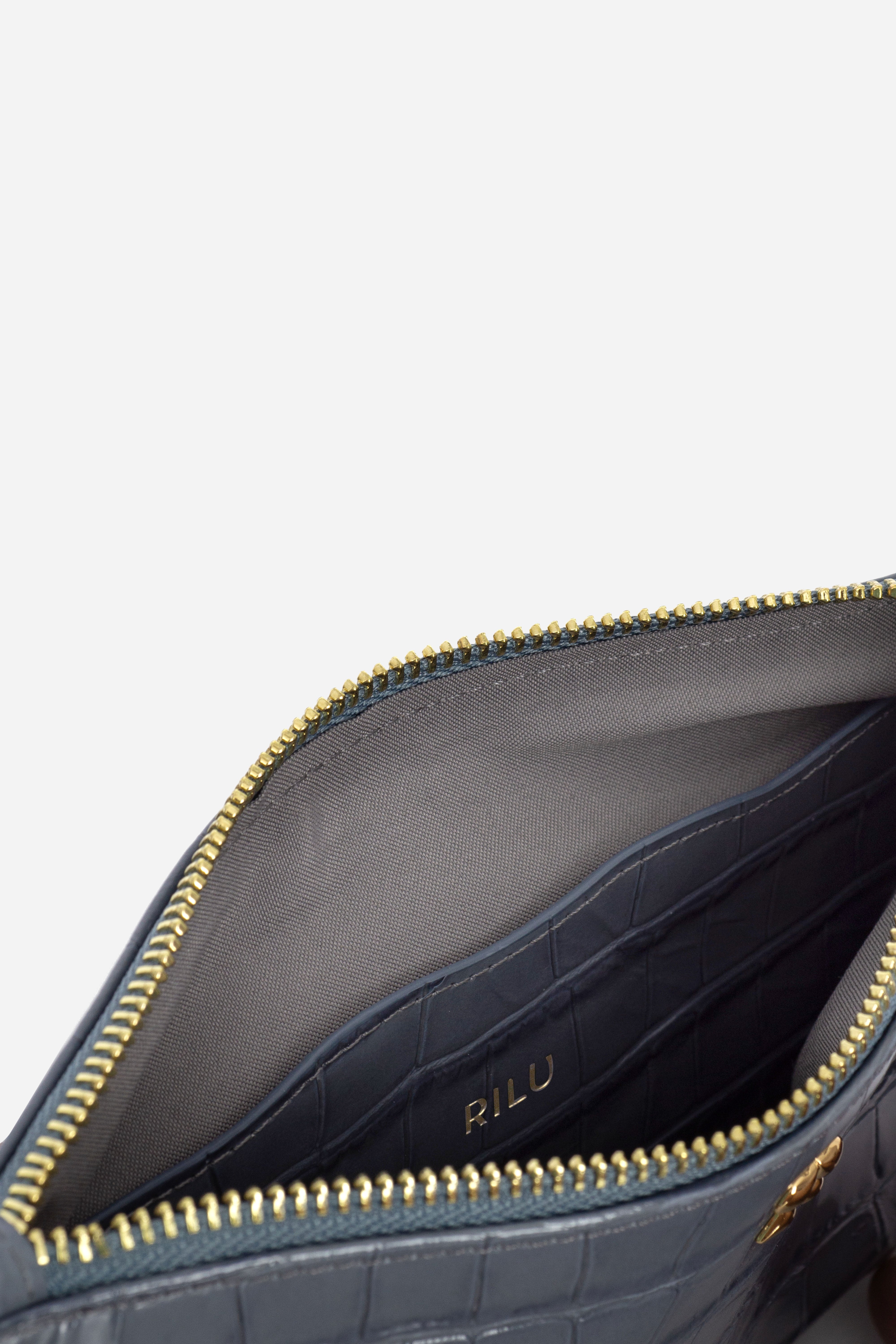 Rilu Kaia ash blue croco print clutch close-up of croco texture and charm