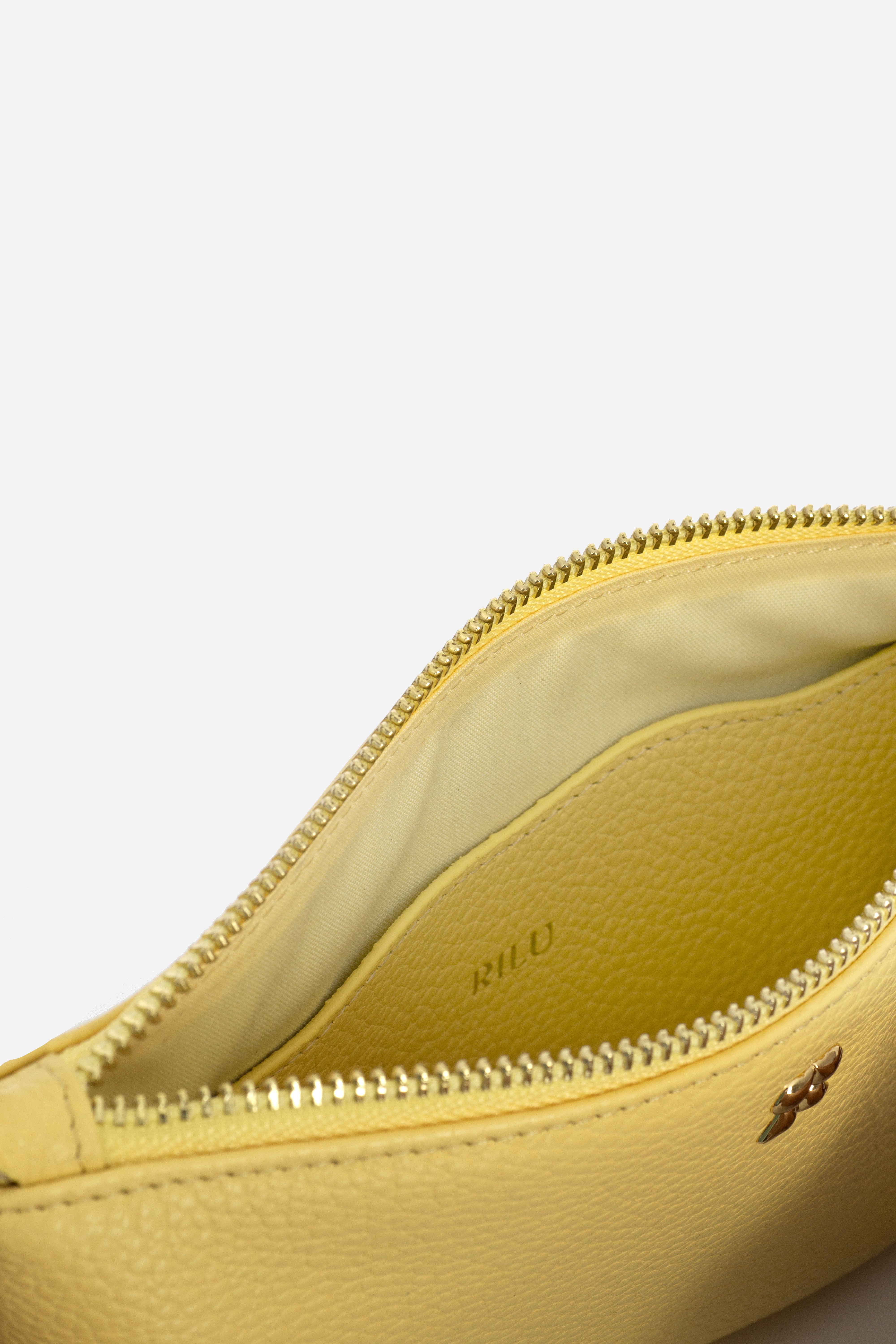 Rilu Kaia butter yellow clutch close-up of Rilu charm and chain detail