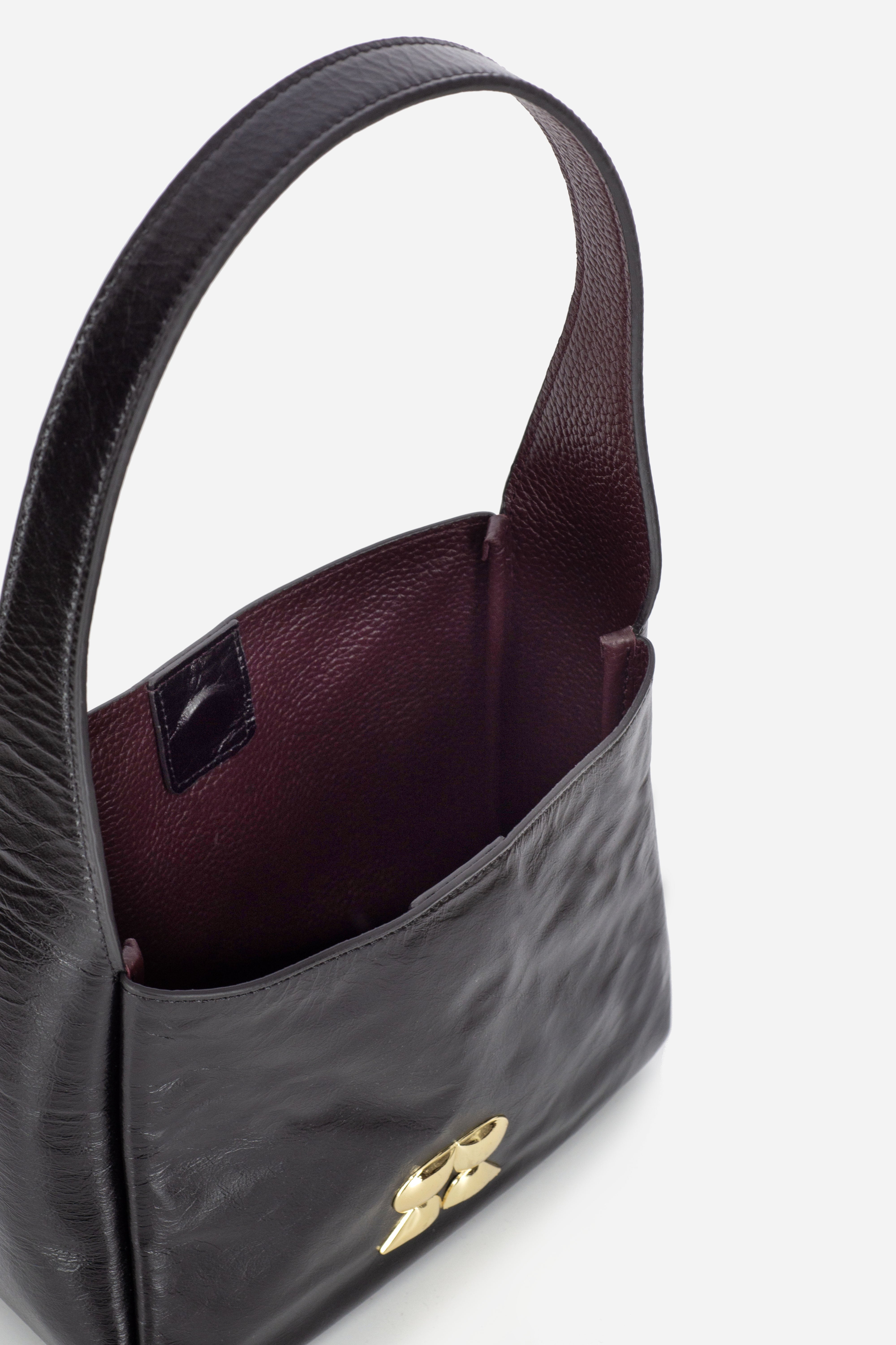 Rilu Camellia black leather shoulder bag close-up of gold hardware and leather