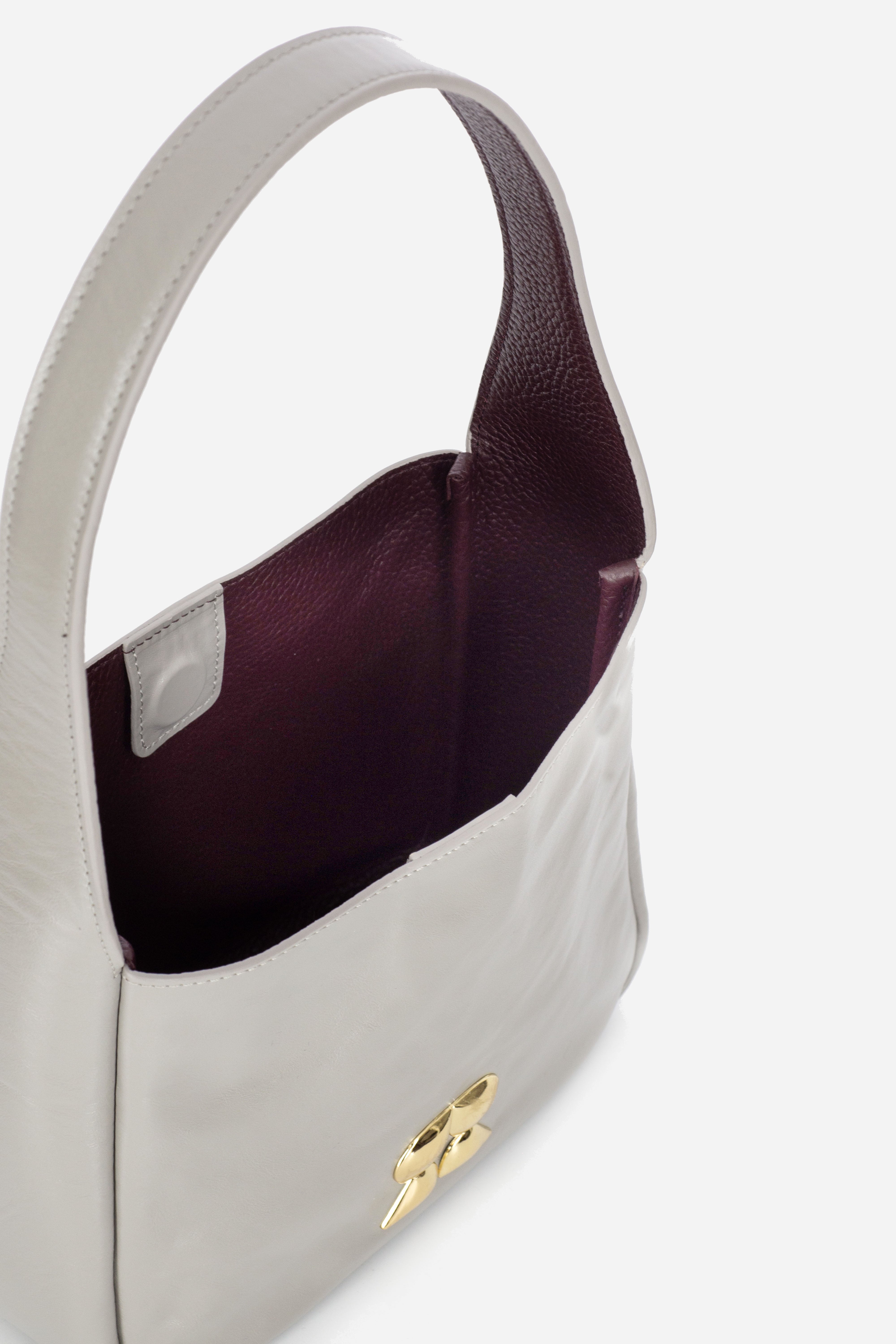 Rilu Camellia stone gray leather shoulder bag close-up showing contrasting interior color