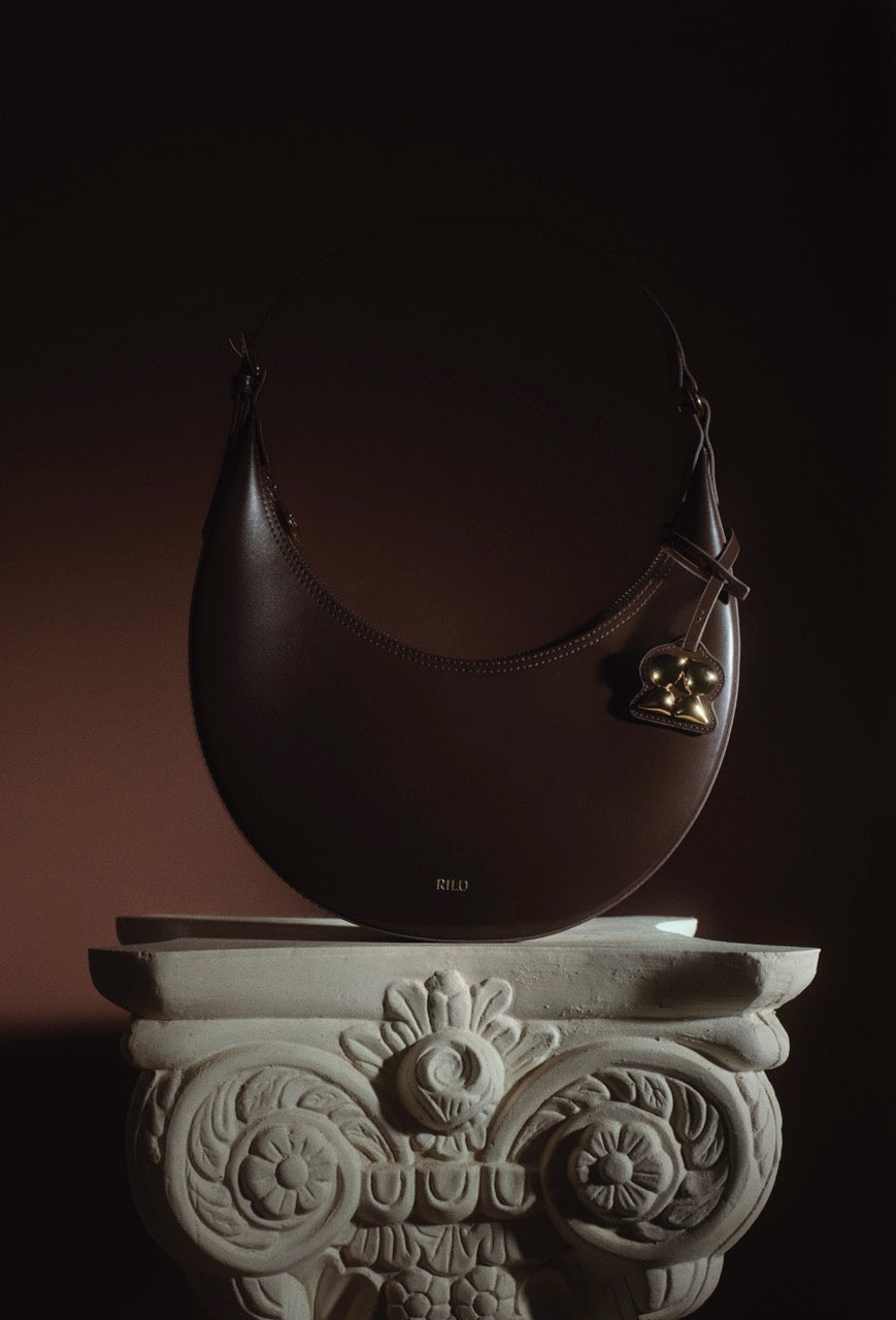Rilu Luna Espresso leather bag displayed in a still-life setup