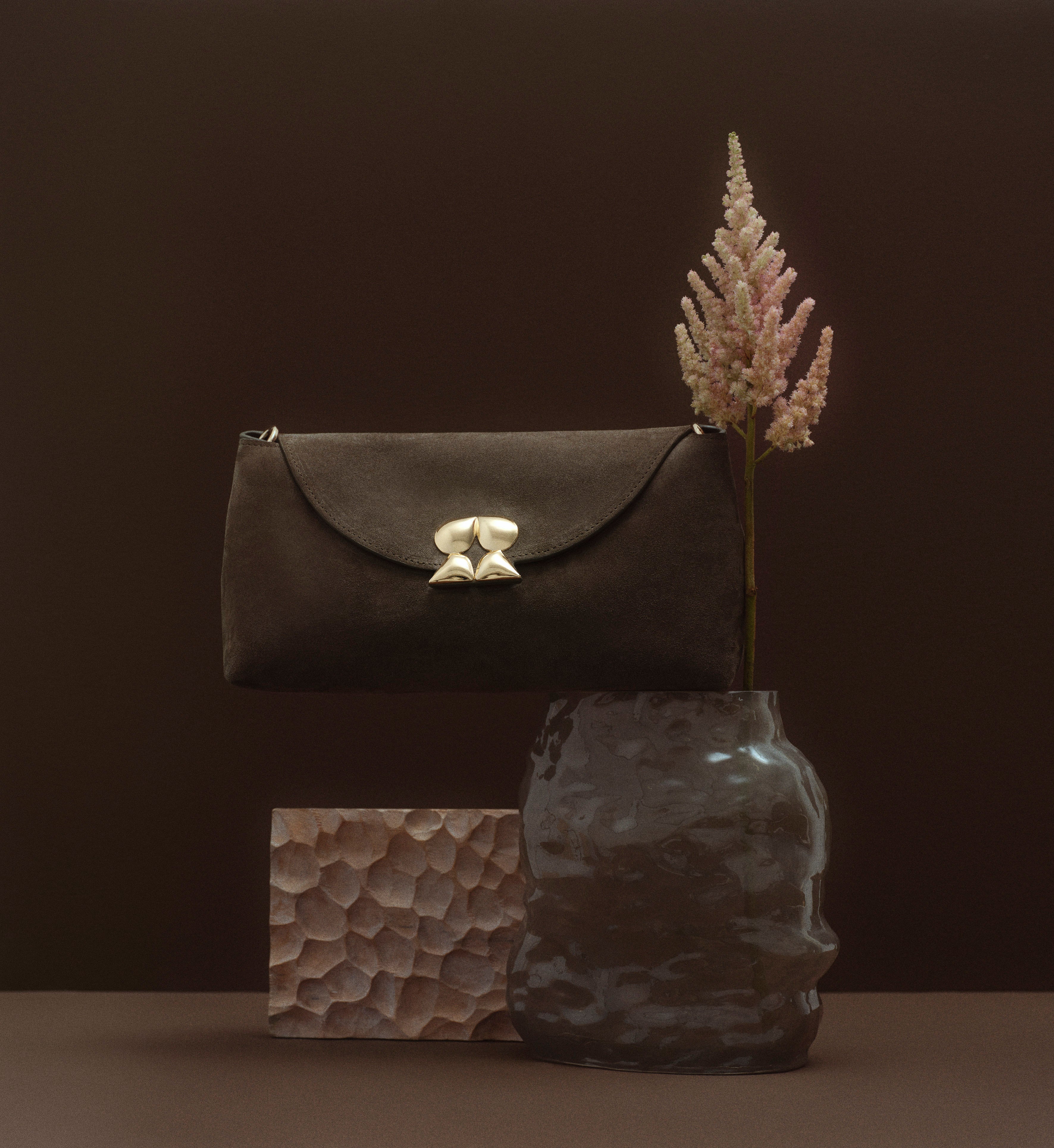 Still-life photo of Rilu Rhea brown leather bag with floral styling